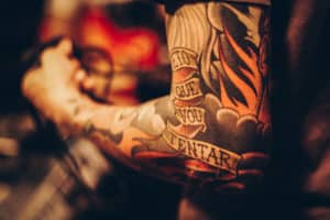 Image of an arm with a lot of tattoos by matheus ferrero